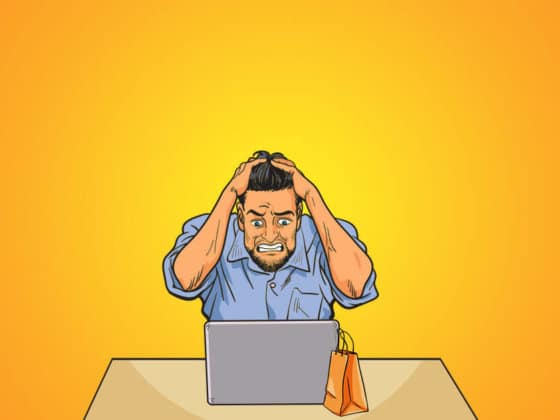 A képen egy férfi látható, amint számítógépe fölött ülve bosszankodik a Facebook ecommerce hirdetéseken.
